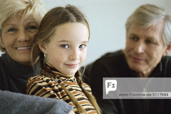 Young girl with grandparents  portrait