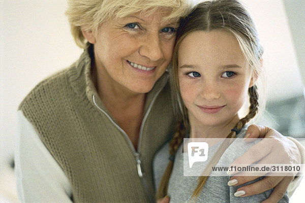 Senior woman with arm around granddaughter  portrait