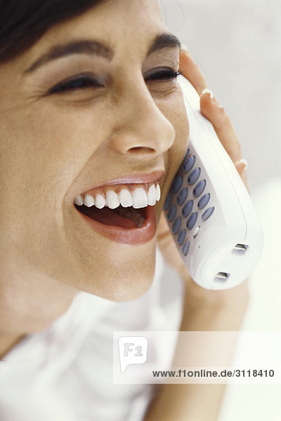 Woman on phone call  smiling and laughing