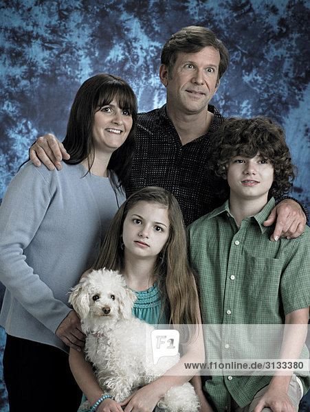Portrait of a family with poodle