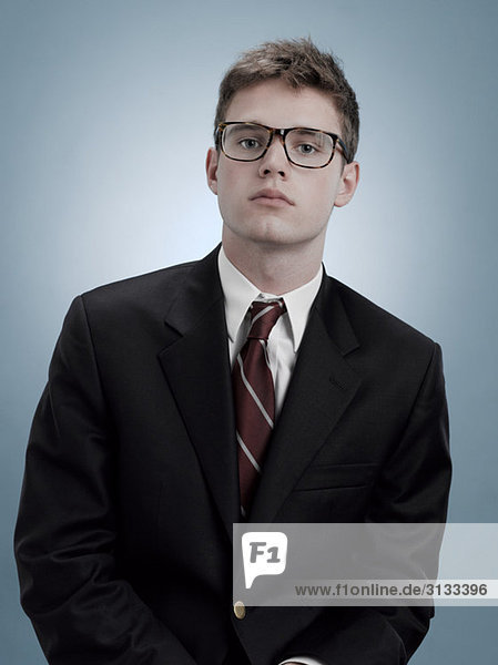 Portrait of a boy in suit and glasses
