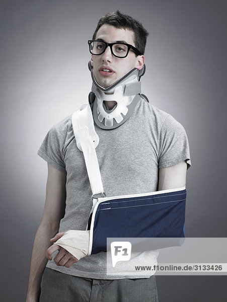 Man with neck brace and arm in sling