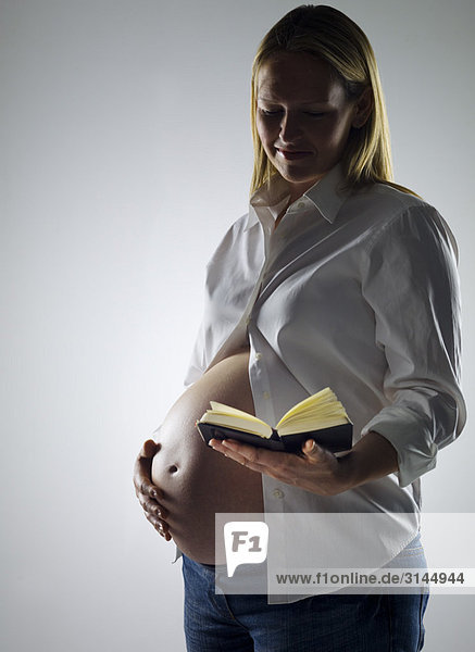 pregnant woman reading diary