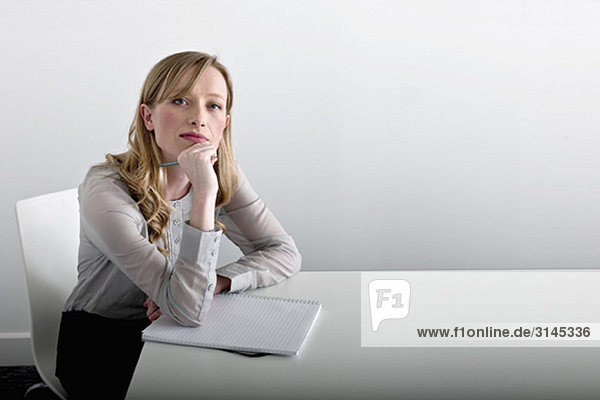 woman sitting with notepad