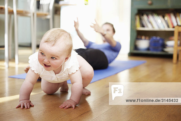 mum doing yoga with a baby