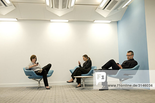 Portrait of a business group texting