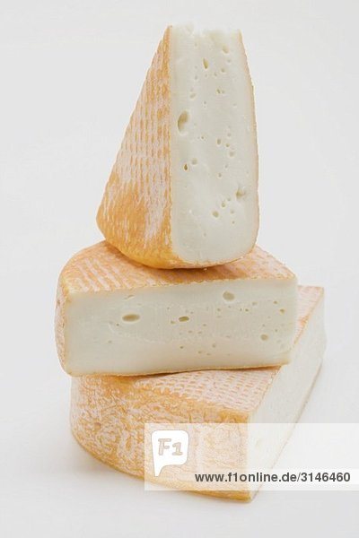 Three pieces of washed-rind cheese