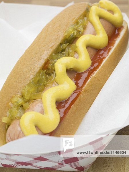 A hot dog with mustard  onion relish and ketchup