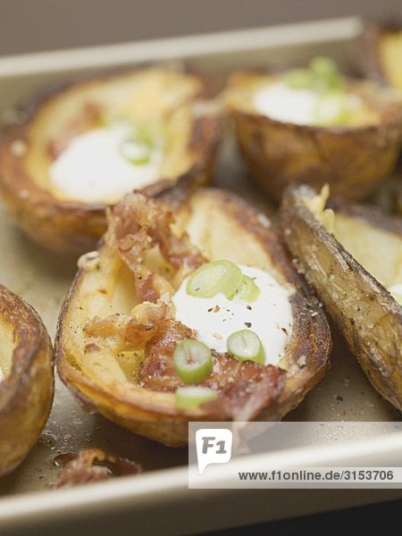 Baked potato skins with bacon  sour cream and chilli rings