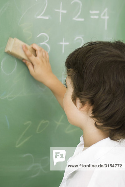 Boy erasing blackboard
