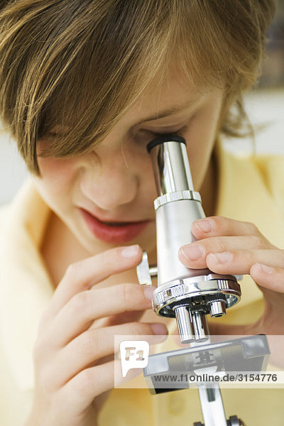 Boy using microscope  close-up