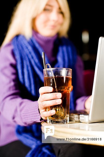 Young woman sitting in a caf using a laptop Sweden.