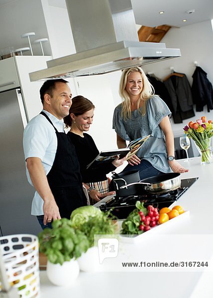 Three people making dinner together Sweden.