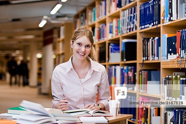 A female student studying in a library Sweden.