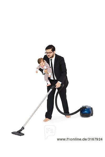 Father and daughter vacuuming.
