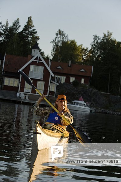 A woman canoing  Stockholm archipelago  Sweden.