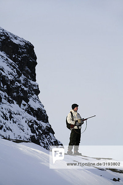 A hunter on a grouse-shooting expedition in the north of Sweden.