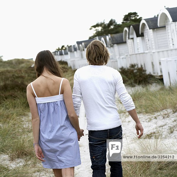 A young couple holding hands  Skane  Sweden.
