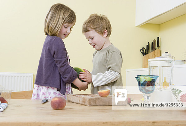 boy and girl preparing fruit