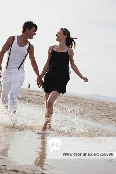 couple running along the beach