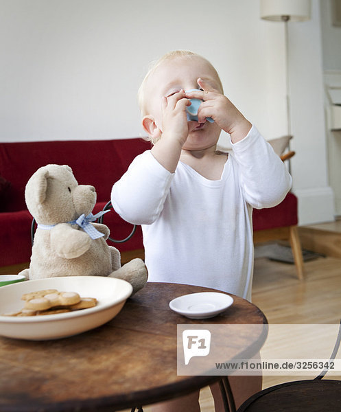 Boy toddler having a pretend cup of tea