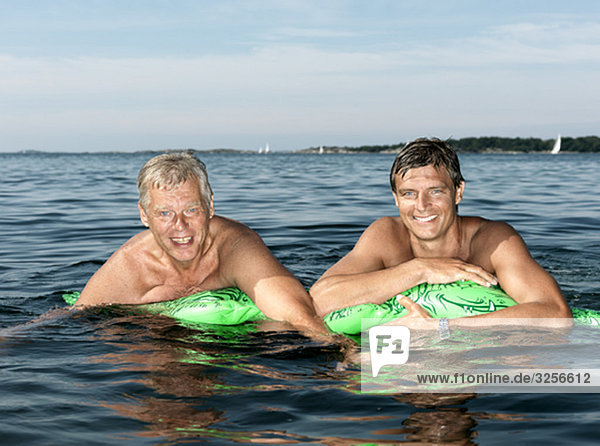Father and son on inflatable crocodile