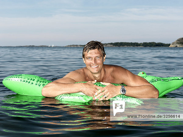 Man with inflatable crocodile
