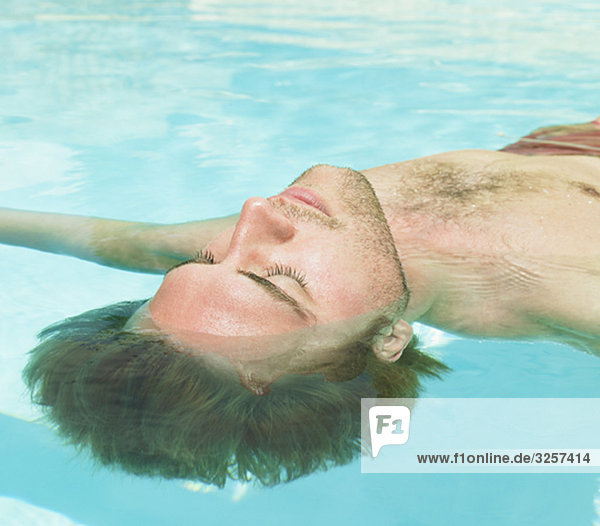 young man floating in water