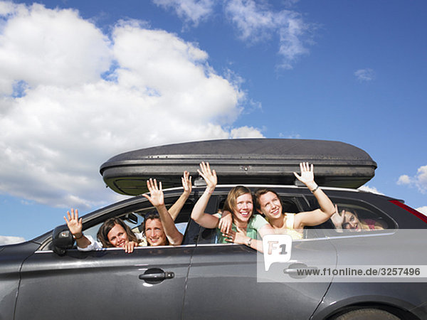 girls waving out of car windows