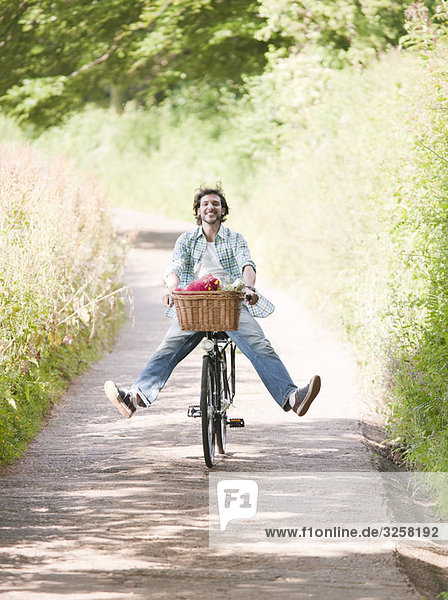 Man cycling in country lane
