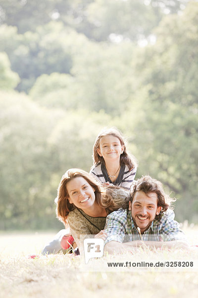 Family lying on blanket in countryside