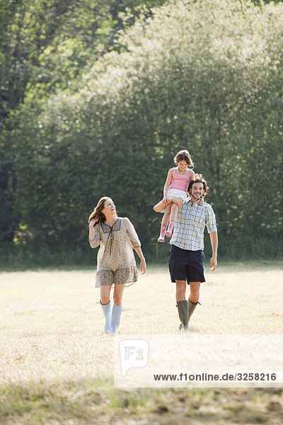 Family walking through country field
