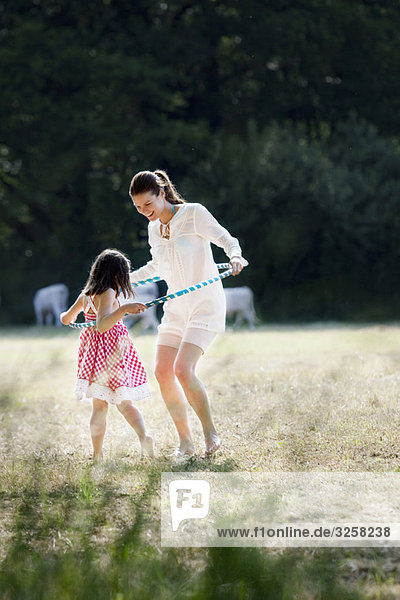 Mother and daughter playing with hoop