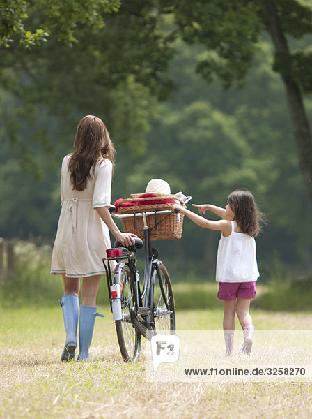 Mother and child with bike and picnic