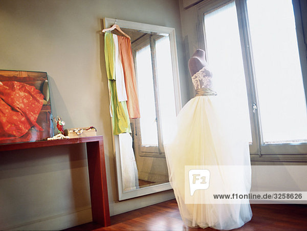 A weddingdress in front of a mirror