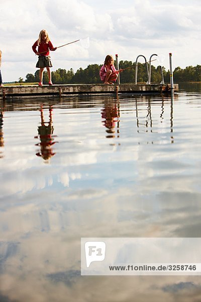 Two girls fishing  Sweden.