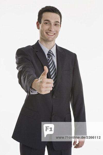 Businessman thumbs up  smiling  portrait