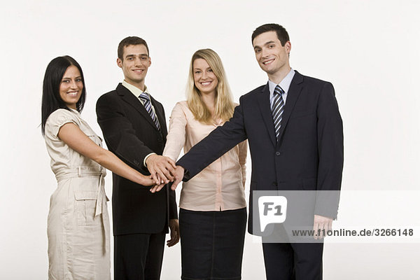 Businesspeople in a huddle  smiling  portrait