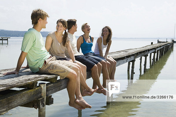 Germany  Bavaria  Ammersee  Young people relaxing on jetty