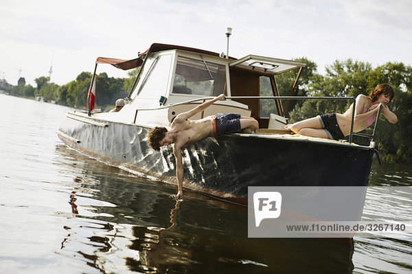 Germany  Berlin  Young couple on motor boat