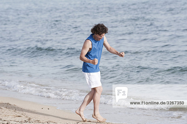 Spain  Mallorca  Man jogging on beach