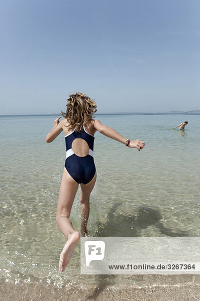 Spain  Mallorca  Girl (10-11) running into sea