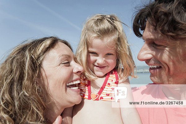 Spain  Mallorca  Family on beach  smiling  portrait