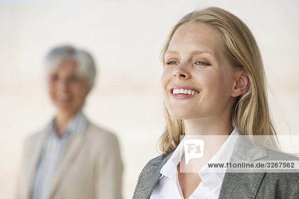 Two businesswomen  smiling  portrait