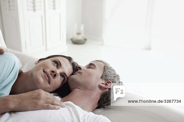 Germany  Hamburg  Couple lying in bed  side view  portrait