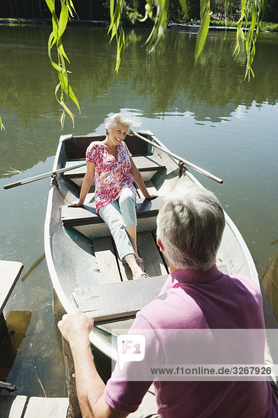 Italy  South Tyrol  Senior couple in rowing boat  elevated view  portrait