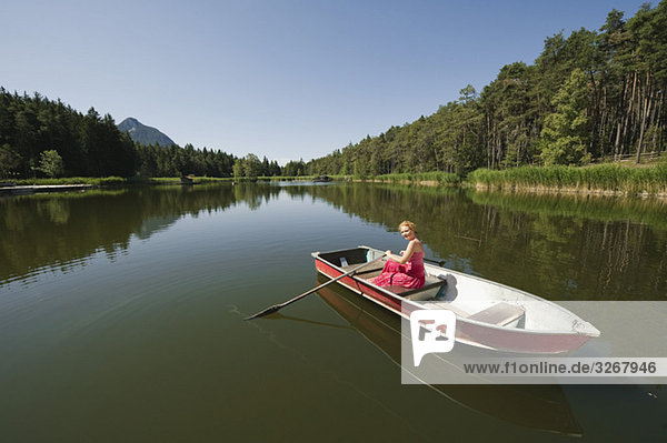 Italy  South Tyrol  Woman rowing boat  smiling  portrait