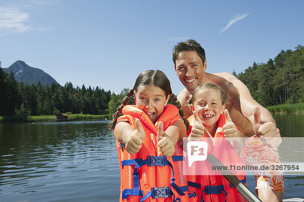 Italy  South Tyrol  Father and children (6-7) (8-9)  children wearing life jackets  smiling  portrait