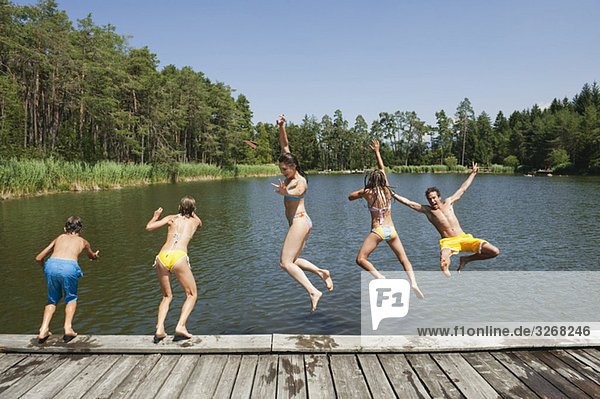 Italy  South Tyrol  Family jumping into lake