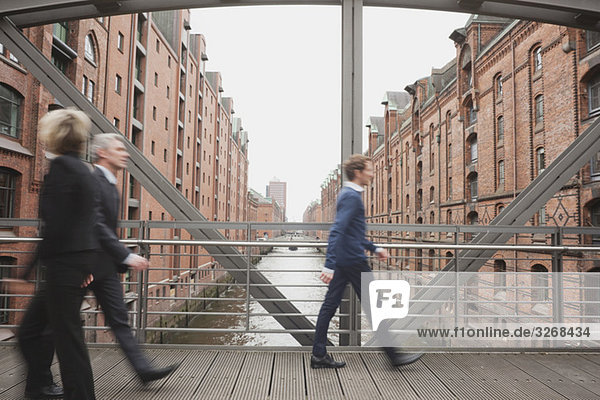 Germany,  Hamburg,  Business people crossing bridge